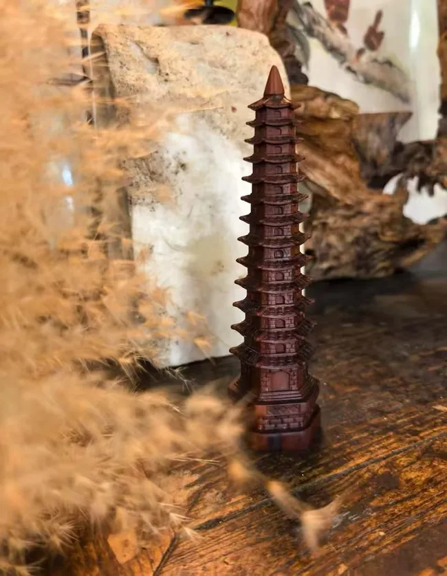 A tall miniature pagoda with repeated projecting tiers.