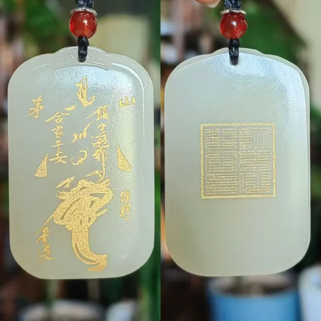 Two faces of a pale pendant, with lettering and a square seal design.