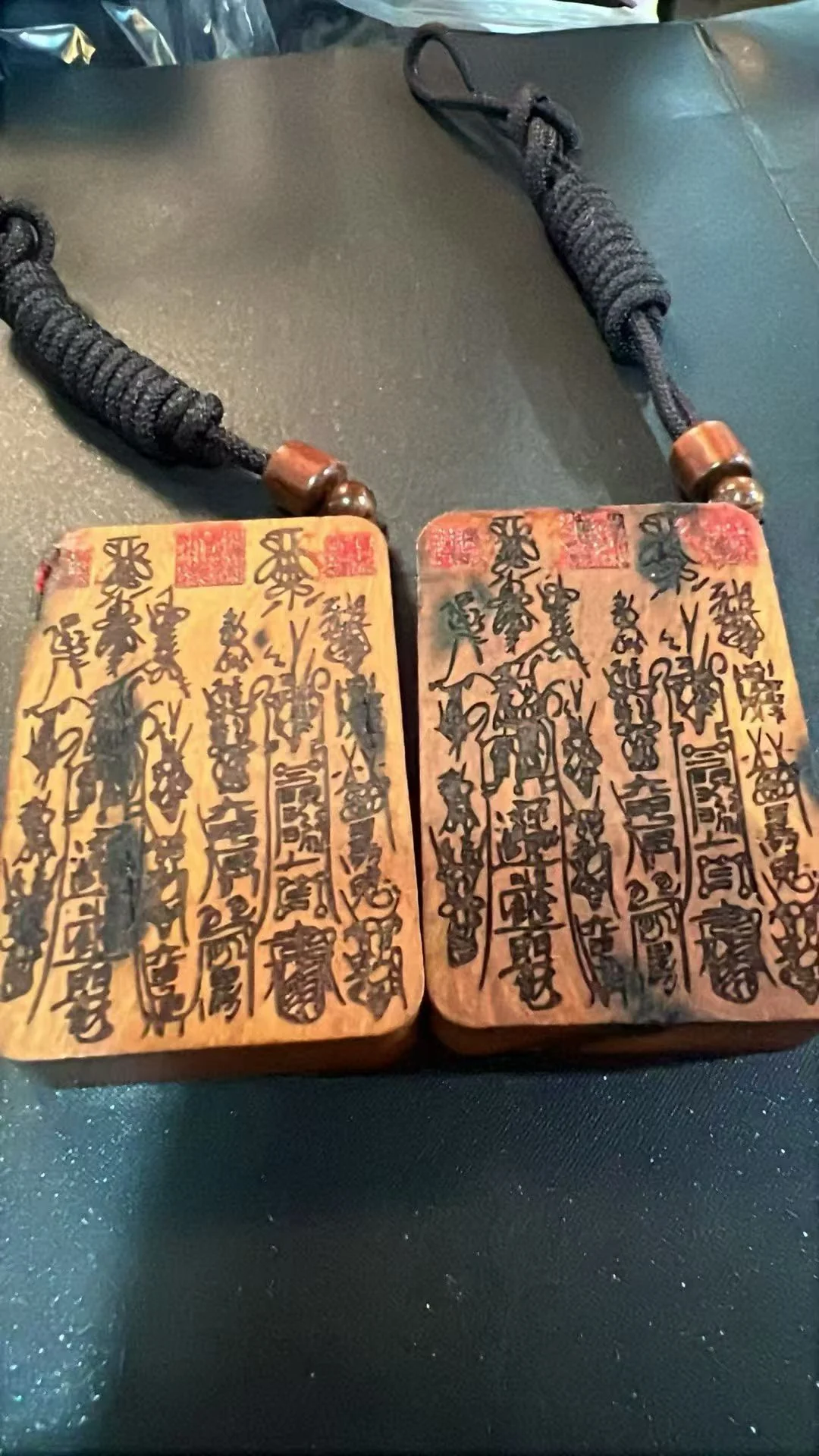 Two rectangular pendants bearing dense talismanic inscriptions